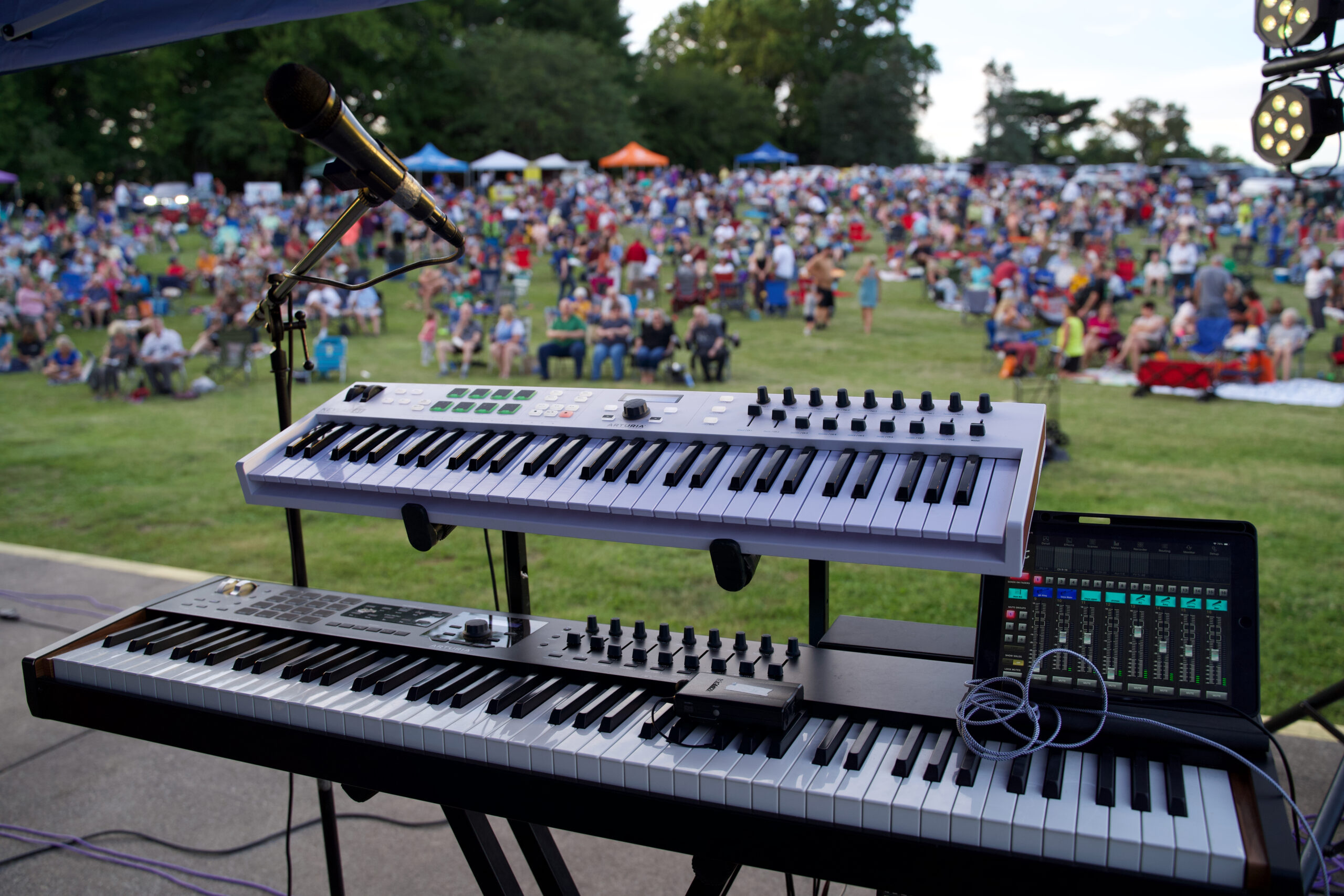 Keyboard set up on a stage for a live performance.