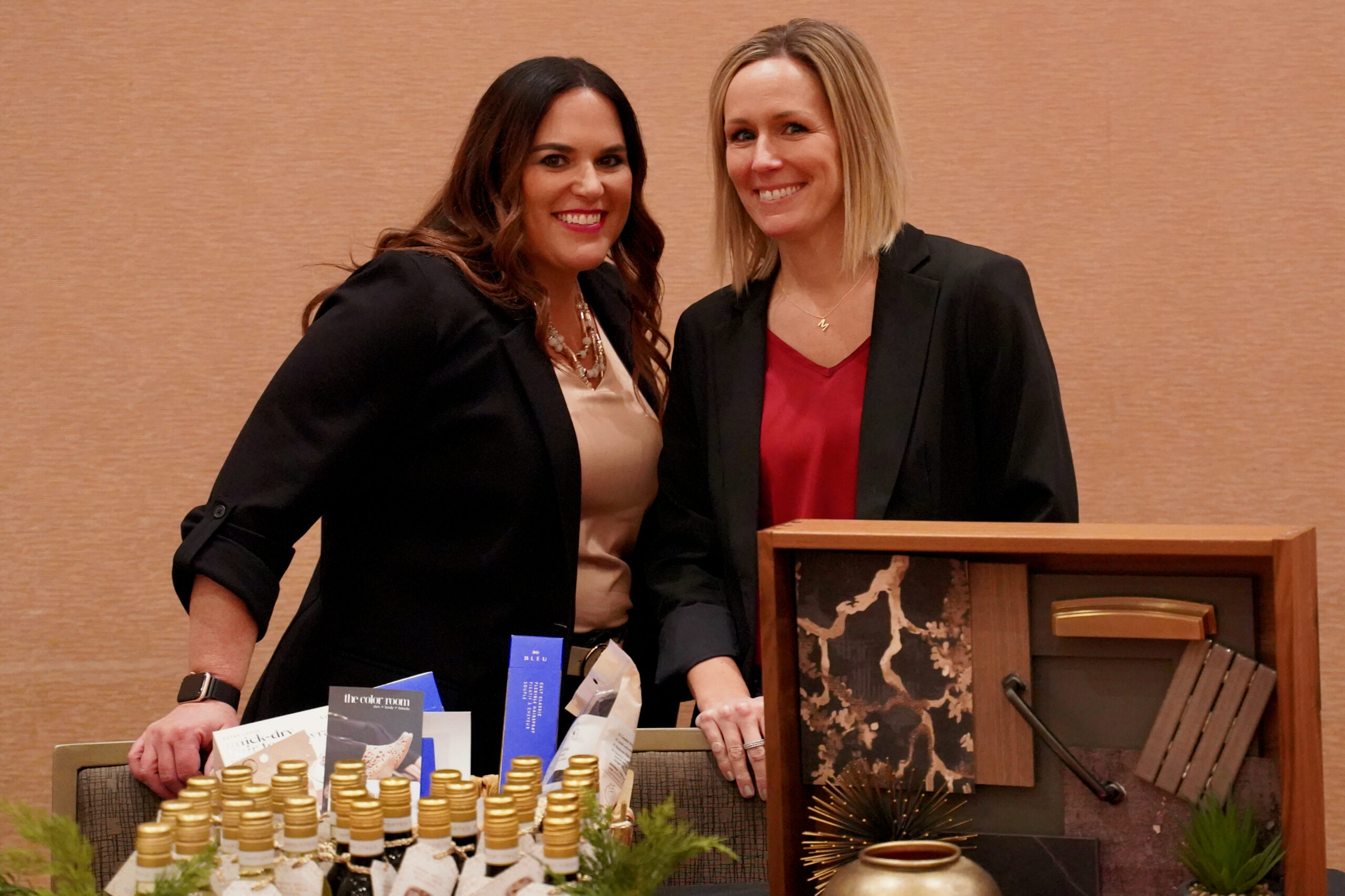 Professional event photography in St. Louis showing two women standing behind a table.