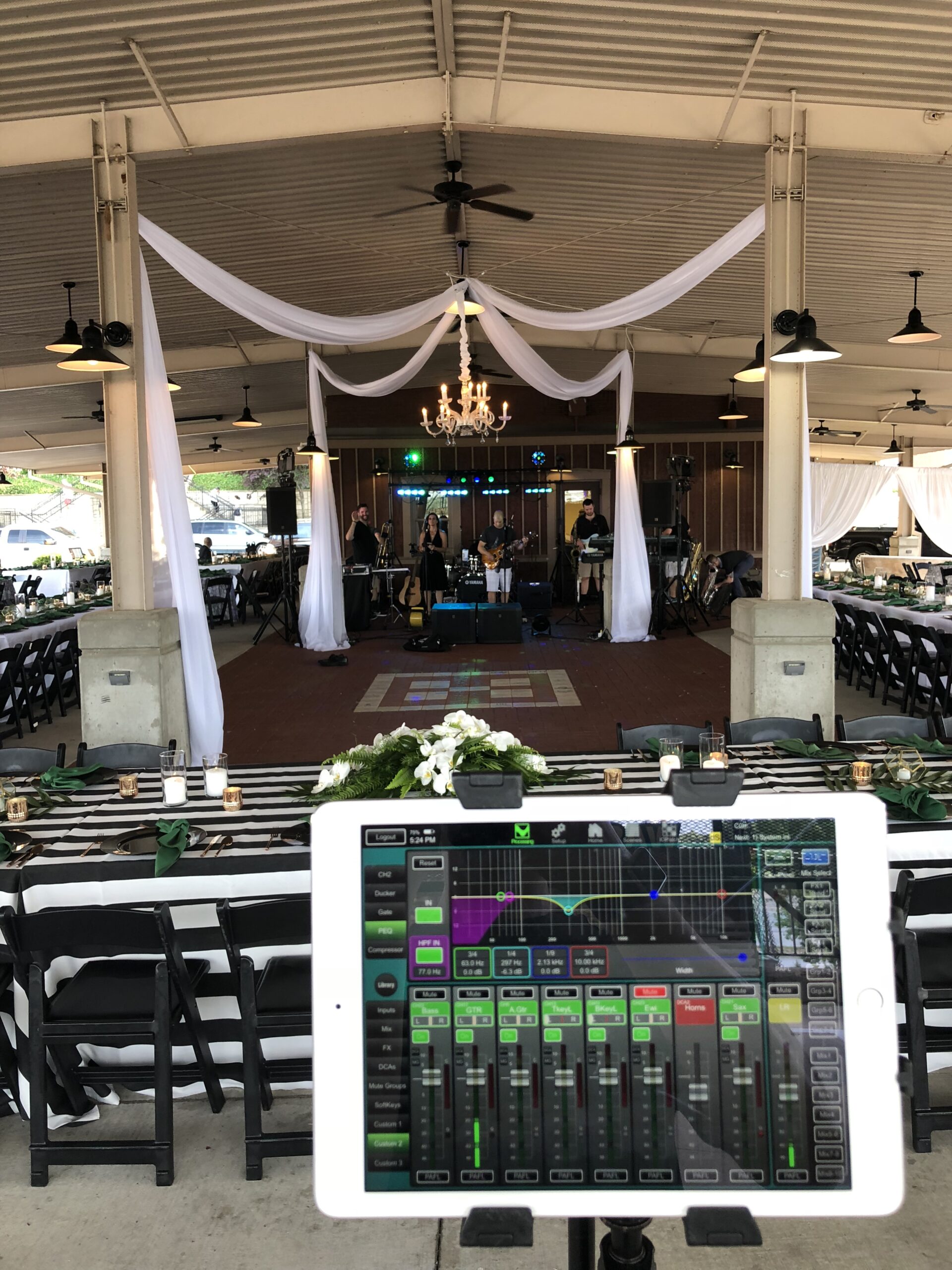 An iPad displaying audio and lighting controls for a wedding venue.